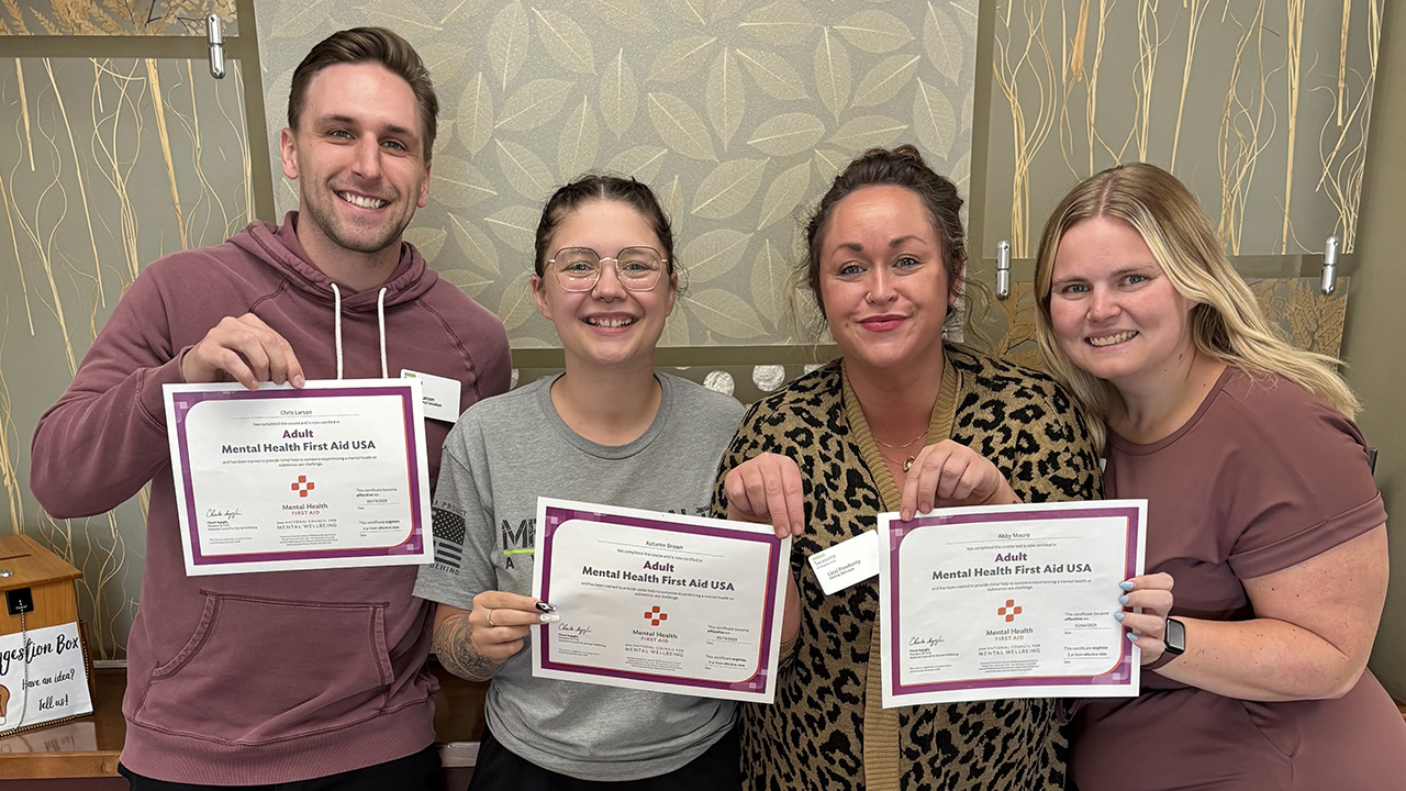 Ecumen partners holding MHFA certificates.
