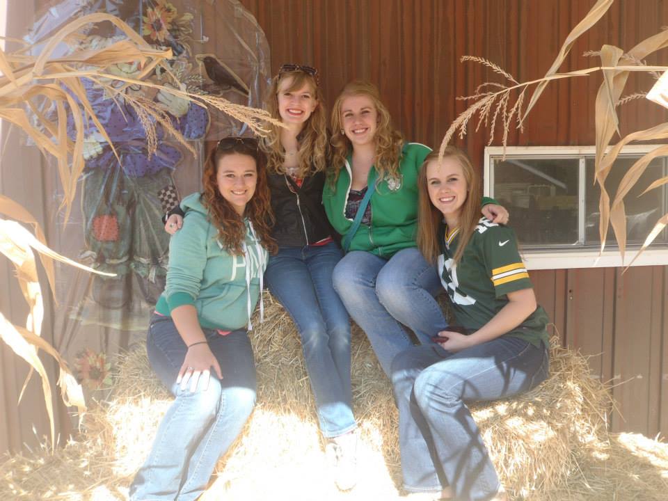 Girls sitting on hay bales