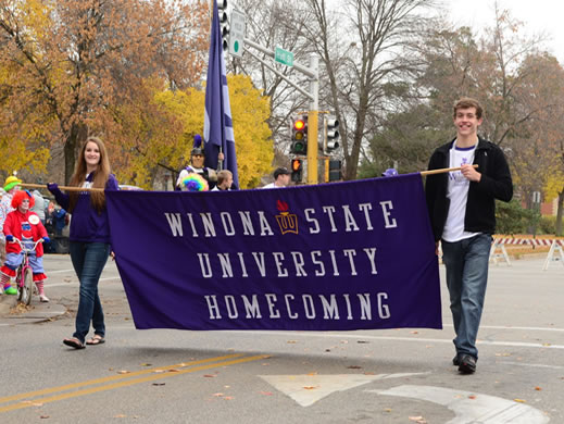 Students carry a banner in last year's Homecoming parade. 