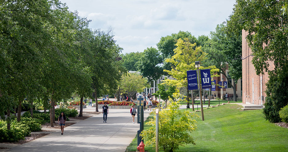 Students walking across campus in the summer time.