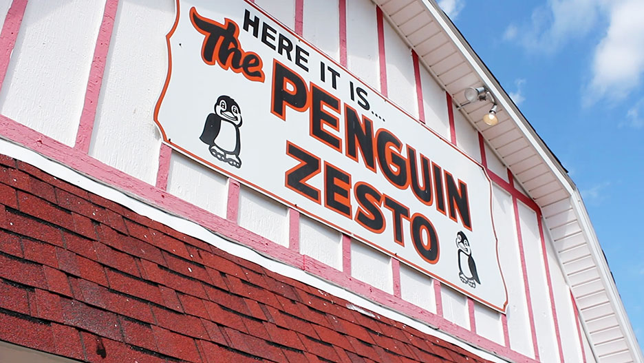Video still of the Penguin Zesto sign