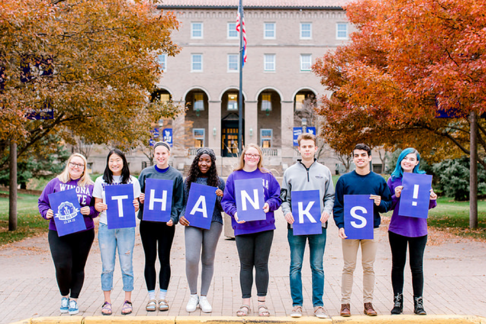 Students holding thank you sign 