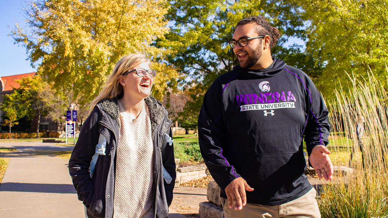 Two students laugh as the walk through WSU campus.