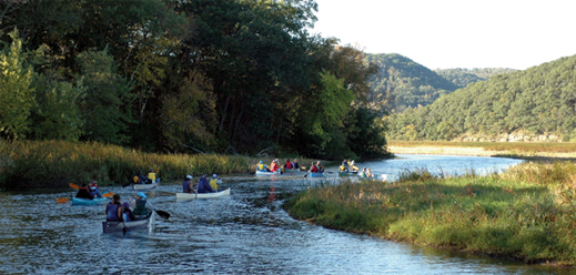 Students canoeing down a river