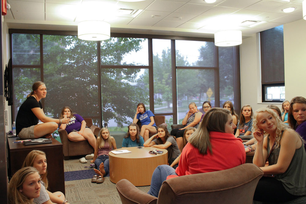 Students attending a hall council meeting in the residence halls.