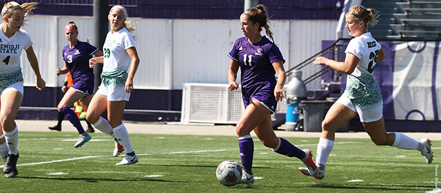 A WSU soccer player protects the ball from an opponent. 