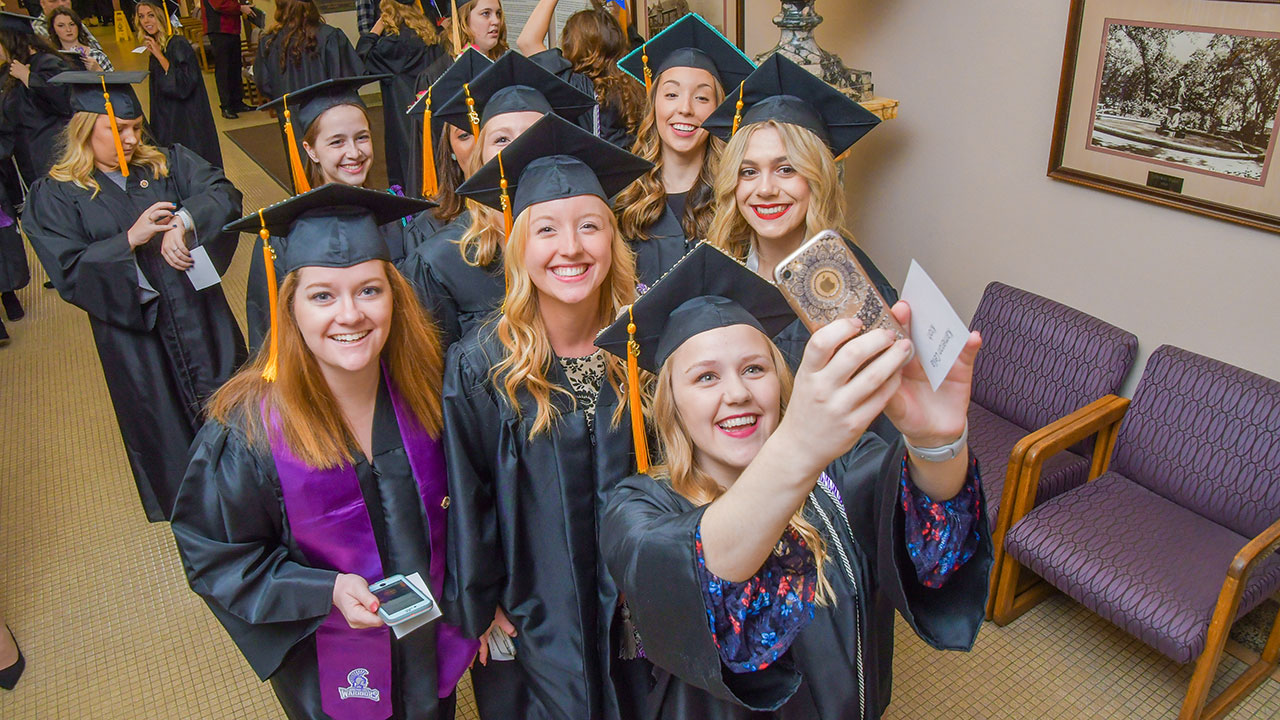WSU graduates taking a selfie together