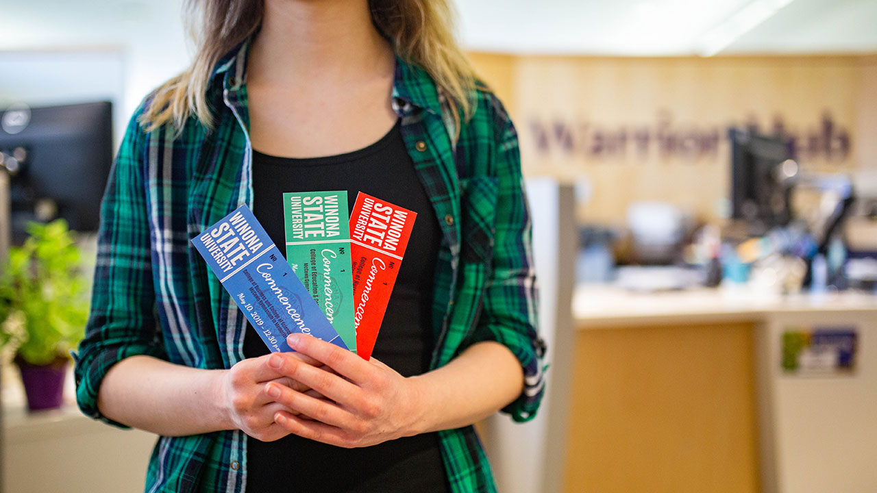 A WSU student holding the new graduation tickets.