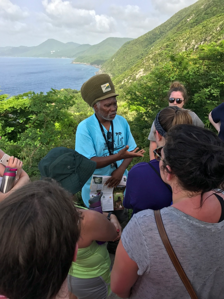 Professor Davis teaches students while on a hike