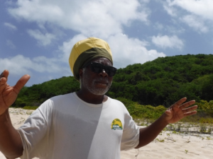 Professor Davis gestures with his hands while teaching on the beach