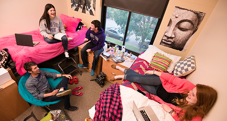 Students talking in a residence hall room
