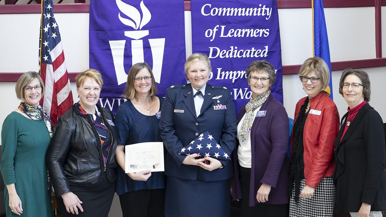 Major Mackenzie Johnson presents military flag to faculty at Winona State University-Rochester