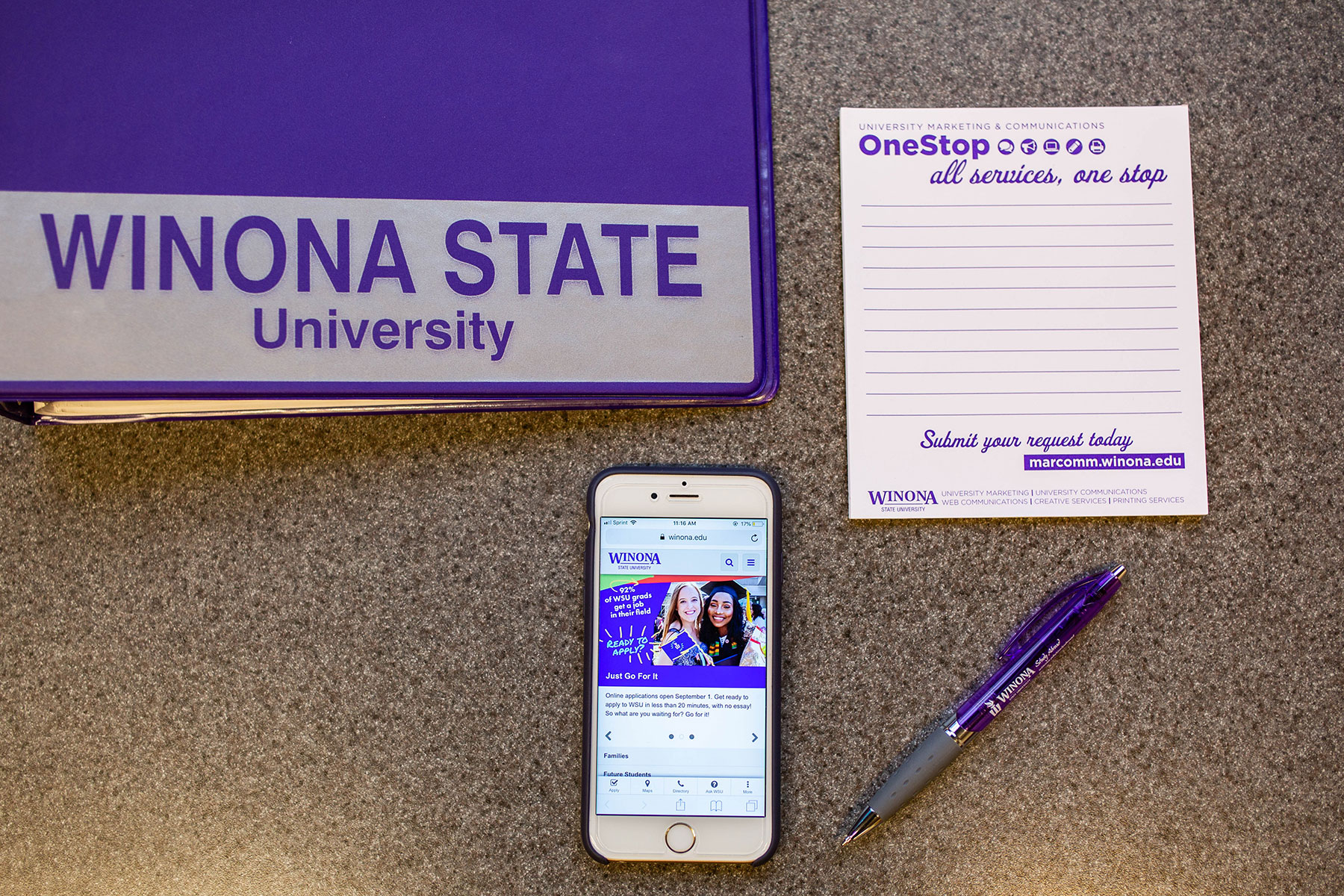 Winona State binder, notepad, pen and phone
