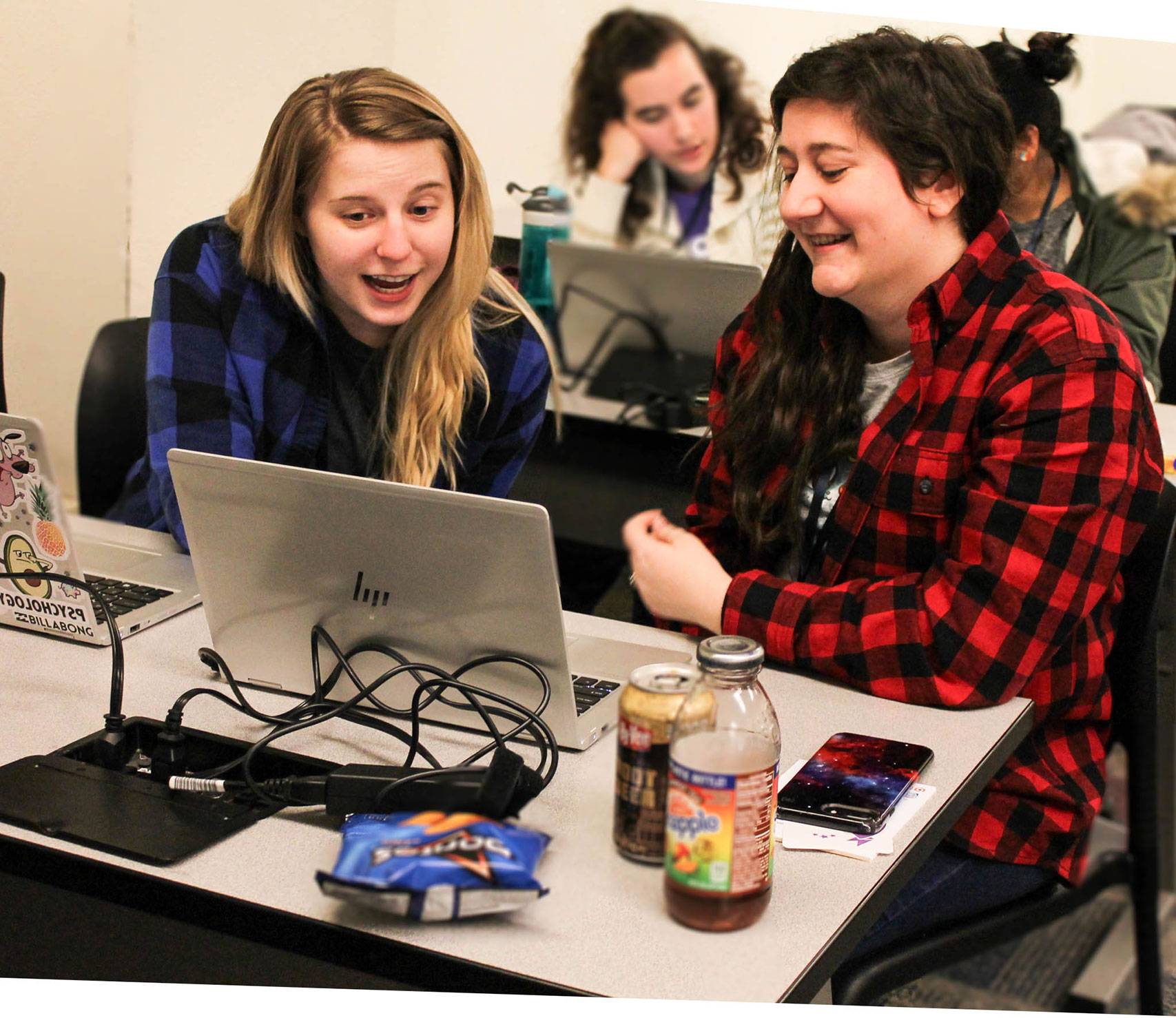 Two girls working on a project together at the WSU Hackathon event on campus.